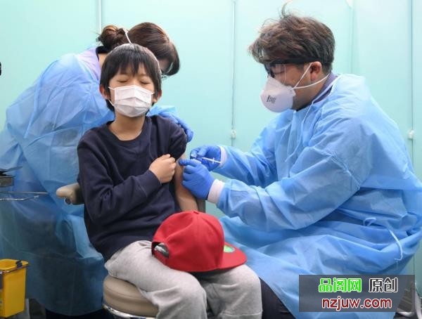 A boy receives a COVID-19 vaccine in Tokyo's Adachi Ward on Feb. 26. | KYODO
